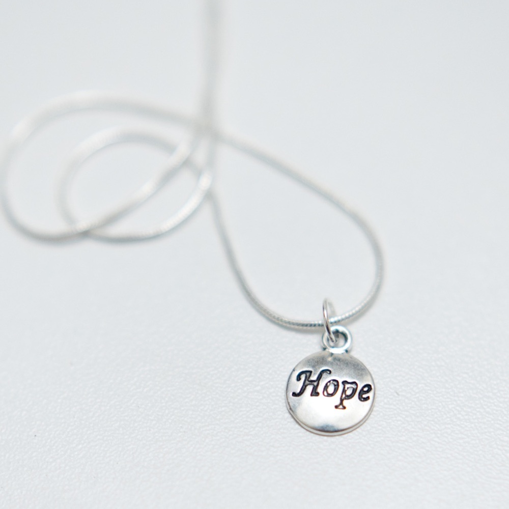 22 inch silver necklace with charm that says hope